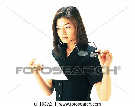 Businesswoman reading news paper with glasses off, Side View View Large Photo Image Stock Image - Businesswoman reading news paper with glasses off, Side View. Fotosearch
