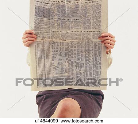 Stock Photo - Businesswoman reading news paper with crossed legs, Front View, Waist Down. Fotosearch