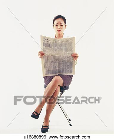 Businesswoman reading news paper with crossed legs, Front View View Large Photo Image Stock Photograph - Businesswoman reading news paper with crossed legs, Front View. Fotosearch