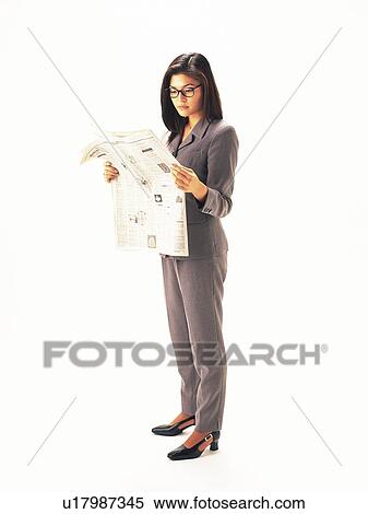 Businesswoman standing and reading news paper, Side View View Large Photo Image Stock Photography - Businesswoman standing and reading news paper, Side View. Fotosearch