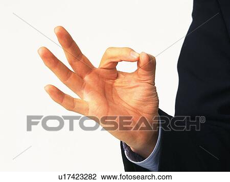 Stock Image - Close up shot of hand, Thumb and index finger making circle shape, Front View. Fotosearch