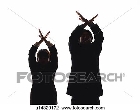 Bsinessman and businesswoman crossing arms above heads, Front View, Silhouette View Large Photo Image Stock Image - Bsinessman and businesswoman crossing arms above heads, Front View, Silhouette . Fotosearch