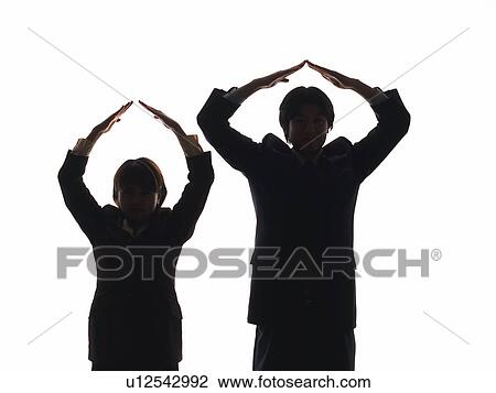 Bsinessman and businesswoman making triangle above heads with hands, Front View, Silhouette View Large Photo Image Stock Image - Bsinessman and businesswoman making triangle above heads with hands, Front View, Silhouette . Fotosearch