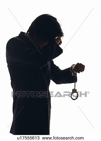 Bsinessman crying with hand in handcuffs, Side View, Silhouette View Large Photo Image Stock Image - Bsinessman crying with hand in handcuffs, Side View, Silhouette . Fotosearch