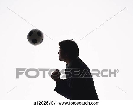 Stock Photo - Bsinessman heading a football, Side View, Silhouette . Fotosearch