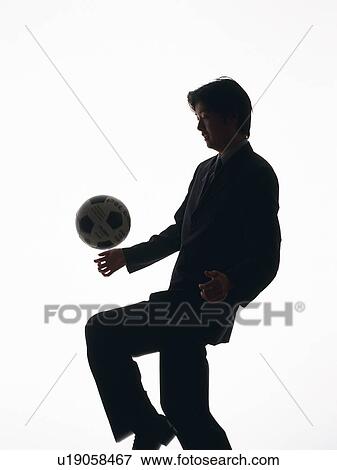 Bsinessman heading a football, Side View, Silhouette View Large Photo Image Stock Photo - Bsinessman heading a football, Side View, Silhouette . Fotosearch