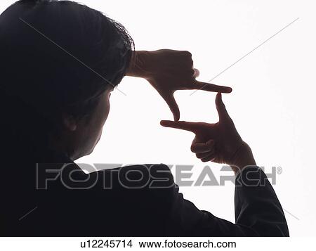 Picture - Bsinessman making frame with fingers, Rear View, Silhouette . Fotosearch
