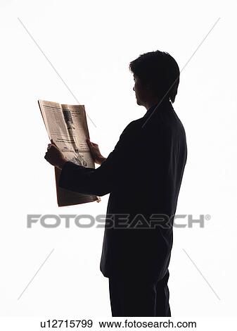 Stock Photo - Bsinessman reading news paper, Rear View, Silhouette . Fotosearch