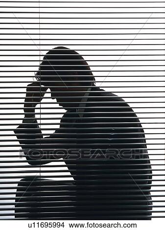 Picture - Bsinessman sitting and troubled by the blind, Side View, Silhouette . Fotosearch