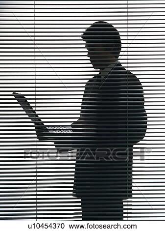 Bsinessman standing and using laptop computer by the blind, Side View, Silhouette View Large Photo Image Stock Image - Bsinessman standing and using laptop computer by the blind, Side View, Silhouette . Fotosearch