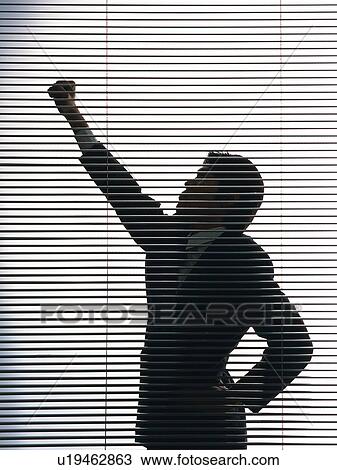Bsinessman standing by the blind with fist up in the air, Side View, Silhouette View Large Photo Image Stock Image - Bsinessman standing by the blind with fist up in the air, Side View, Silhouette . Fotosearch