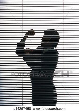 Stock Photo - Bsinessman standing by the blind with victory pose, Side View, Silhouette . Fotosearch