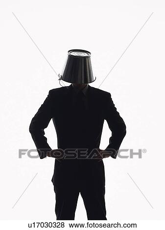 Stock Photo - Bsinessman standing with bucket covering head, Front View, Silhouette . Fotosearch