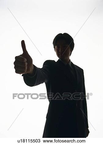 Stock Image - Bsinessman standing with thumb up in the air, Front View, Silhouette . Fotosearch