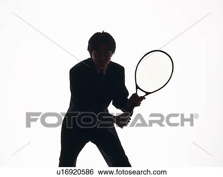 Stock Photograph - Bsinessman swinging a tennis racket, Front View, Silhouette . Fotosearch