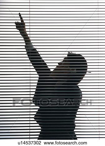 Bsinessman using mobile phone and pointing up by the blind, Side View, Silhouette View Large Photo Image Stock Image - Bsinessman using mobile phone and pointing up by the blind, Side View, Silhouette . Fotosearch