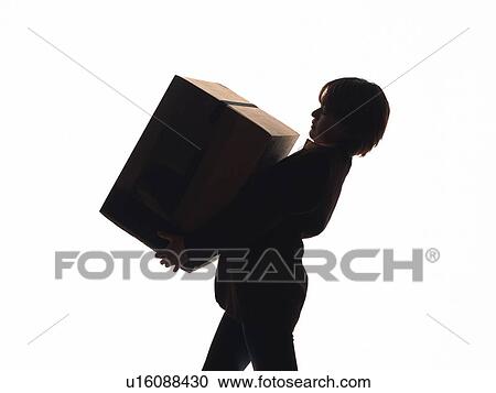 Stock Image - Bsinesswoman carrying a cardboard box, Side View, Silhouette . Fotosearch
