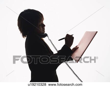 Bsinesswoman holding handset by shoulder and writing down on paper, Side View, Silhouette View Large Photo Image Stock Photo - Bsinesswoman holding handset by shoulder and writing down on paper, Side View, Silhouette . Fotosearch