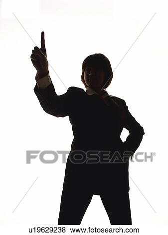 Stock Photo - Bsinesswoman standing and pointing finger up, Front View, Silhouette . Fotosearch