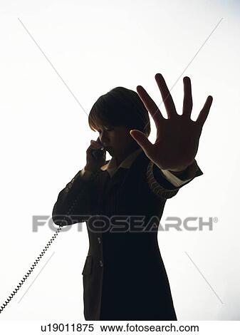 Bsinesswoman talking on the phone and raising palm in front, Side View, Silhouette View Large Photo Image Stock Photography - Bsinesswoman talking on the phone and raising palm in front, Side View, Silhouette . Fotosearch
