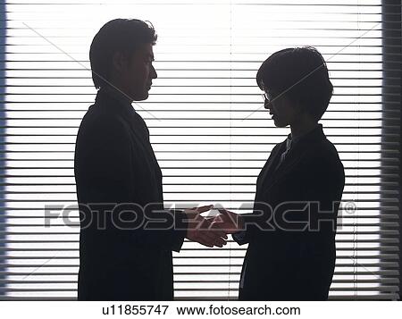 Stock Photo - Businessman and businesswoman shaking hands, Portrait, Side View, High Key, Silhouette. Fotosearch