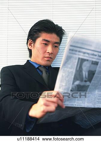 Businessman reading news paper, Portrait, Side View View Large Photo Image Picture - Businessman reading news paper, Portrait, Side View. Fotosearch