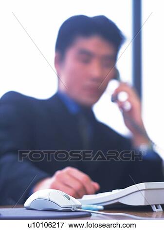Stock Photo - Businessman talking on the phone, Portrait, High Key, Pin Focus. Fotosearch