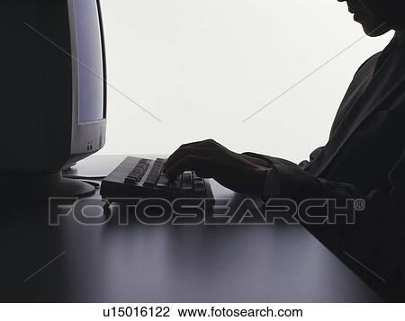 Businessman working with a computer at the desk, Portrait, Side View, Silhouette View Large Photo Image Stock Image - Businessman working with a computer at the desk, Portrait, Side View, Silhouette. Fotosearch