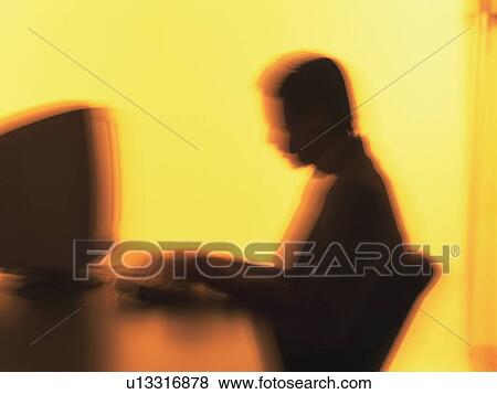 Businessman working with a computer at the desk, Portrait, Side View, Toned Image, Blurred Motion View Large Photo Image Stock Photo - Businessman working with a computer at the desk, Portrait, Side View, Toned Image, Blurred Motion. Fotosearch