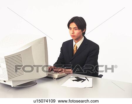Businessman working with a computer at the desk, Portrait, Side View View Large Photo Image Stock Photo - Businessman working with a computer at the desk, Portrait, Side View. Fotosearch