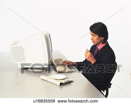 Businessman working with a computer at the desk, Portrait, Side View View Large Photo Image Stock Photo - Businessman working with a computer at the desk, Portrait, Side View. Fotosearch