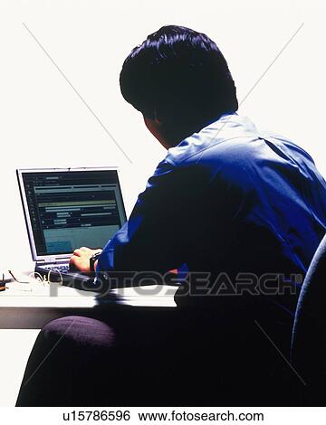 Stock Photograph - Businessman working with a computer at the desk, Portrait, Rear View, Toned Image. Fotosearch