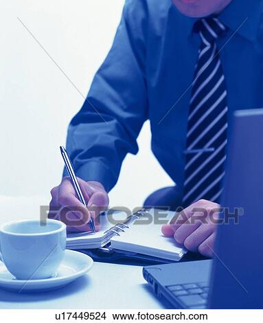 Picture - Businessman writing down on a scheduler, Portrait, Front View, Toned Image. Fotosearch