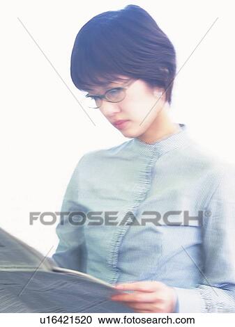 Stock Image - Businesswoman reading news paper, Portrait, High Key, Blurred Motion. Fotosearch