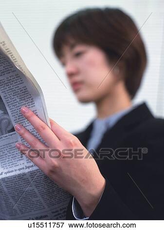 Businesswoman reading news paper, Portrait, Low Angle View, Pin Focus View Large Photo Image Stock Photo - Businesswoman reading news paper, Portrait, Low Angle View, Pin Focus. Fotosearch