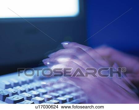 Picture - Fingers typing keyboard, Side View, Toned Image, Blurred Motion. Fotosearch