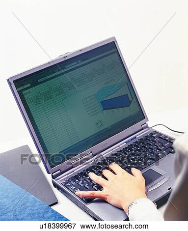 Stock Photo - Hand typing keyboard at the desk, Portrait, High Angle View. Fotosearch