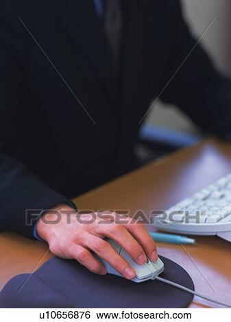 Hand using mouse to work with a computer, High Angle View View Large Photo Image Stock Photograph - Hand using mouse to work with a computer, High Angle View. Fotosearch