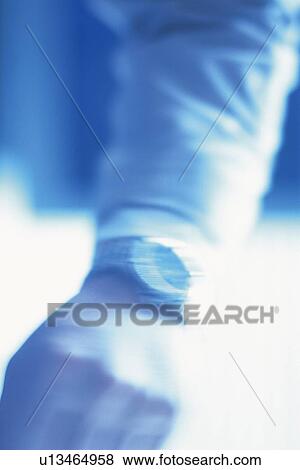 Stock Photo - Hand wearing watch, High Angle View, Toned Image, Blurred Motion. Fotosearch