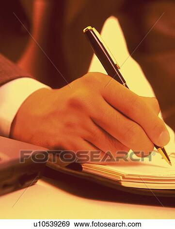 Hand writing down on a scheduler, Close Up, Toned Image View Large Photo Image Stock Photo - Hand writing down on a scheduler, Close Up, Toned Image. Fotosearch