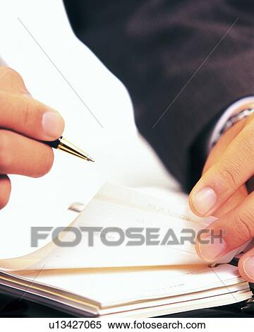 Stock Photography - Hands flipping the pages of the scheduler, Close Up. Fotosearch
