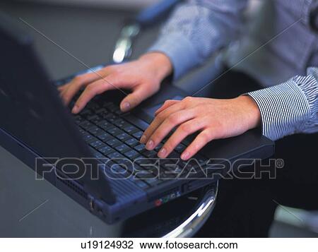 Stock Image - Hands typing keyboard, High Angle View. Fotosearch