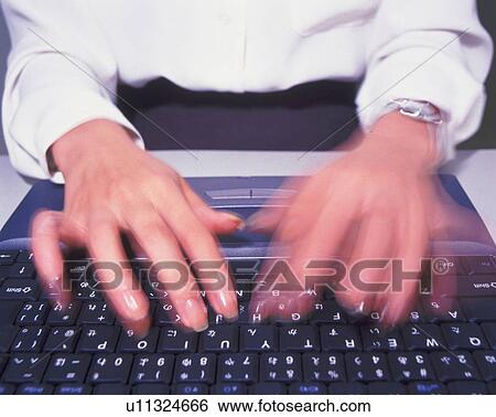 Stock Photograph - Hands typing the keyboard, High Angle View, Blurred Motion. Fotosearch