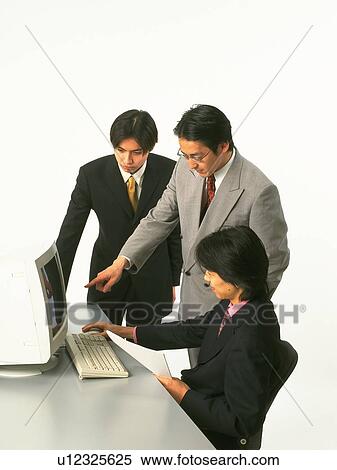 Three businessmen working with a computer at the desk, Portrait, Side View View Large Photo Image Stock Photography - Three businessmen working with a computer at the desk, Portrait, Side View. Fotosearch