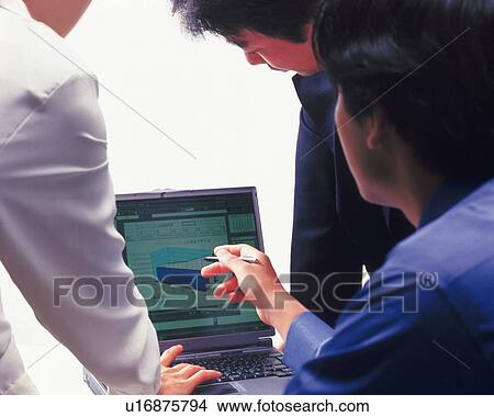 Three people working together with a computer at the desk, Portrait, Rear View, High Key View Large Photo Image Picture - Three people working together with a computer at the desk, Portrait, Rear View, High Key. Fotosearch