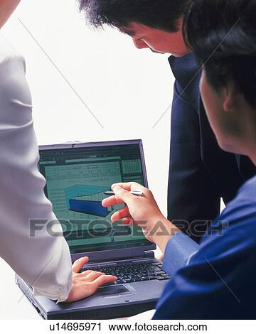 Stock Image - Three people working together with a computer at the desk, Portrait, Rear View, High Key. Fotosearch