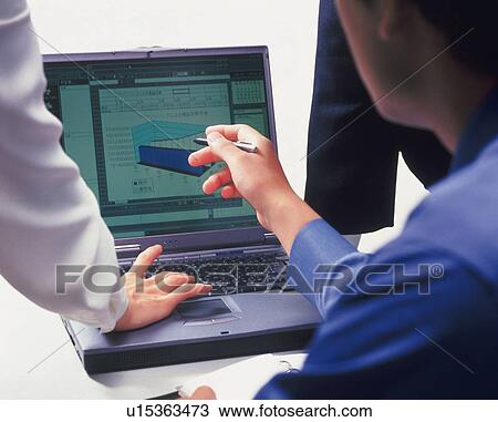 Three people working together with a computer at the desk, Portrait, Rear View View Large Photo Image Stock Image - Three people working together with a computer at the desk, Portrait, Rear View. Fotosearch