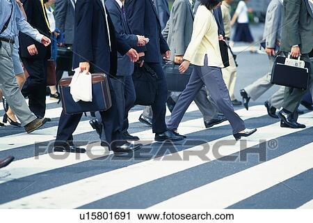Business people crossing at the crosswalk, side view, Tokyo, Japan View Large Photo Image Stock Image - Business people crossing at the crosswalk, side view, Tokyo, Japan. Fotosearch