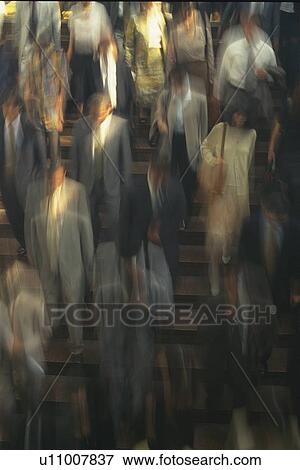 Stock Photo - Business people crossing at the crosswalk, high angle view, blurred motion, Tokyo, Japan. Fotosearch