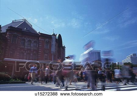 Business people crossing at the crosswalk, low angle view, blurred motion, Tokyo Station, Tokyo, Japan View Large Photo Image Stock Photo - Business people crossing at the crosswalk, low angle view, blurred motion, Tokyo Station, Tokyo, Japan. Fotosearch
